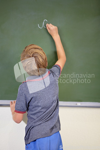 Image of Child, chalkboard and school writing with education, cursive and answer for learning. Back, knowledge and kid development in a study lesson with student in a classroom with chalk and solution