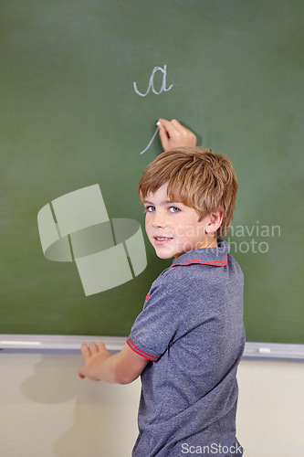 Image of Portrait, chalk and boy drawing on a board for child development, confidence and art for learning. Academic, creative and kid student writing on a blackboard in the classroom with face and happy