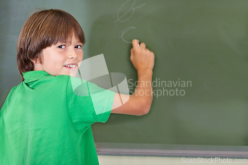 Image of Writing, chalkboard and portrait of kid at school with education and answer for learning. Drawing, knowledge and youth development in study lesson with boy in classroom with chalk and solution