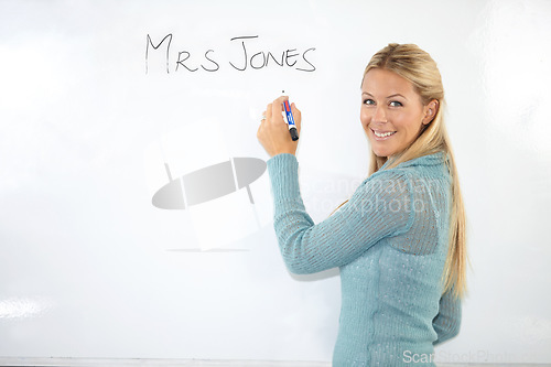 Image of Happy woman, teacher portrait or writing on whiteboard for education, learning or teaching. Smile of a young professor, lecturer or class educator with name in classroom for middle school knowledge