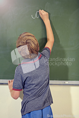 Image of Kid, chalkboard and school with writing education, lecture and answer for learning. Back, knowledge and youth development in a study lesson with male student in classroom with chalk and solution