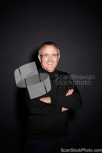 Image of Portrait of mature man in studio with smile, arms crossed and happy with dark fashion style. Pride, relax and senior person isolated on black background with expert knowledge, glasses and wisdom.