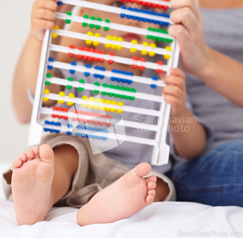 Image of Abacus, math and baby with mother playing, learning and teaching for child development on bed. Bonding, toy and closeup of mom teaching kid, infant or toddler with counting in bedroom at home.