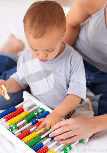 Image of Abacus, toy and baby with mother playing, learning and teaching for child development on bed. Math, bonding and closeup of mom helping kid, infant or toddler with counting in bedroom at home.