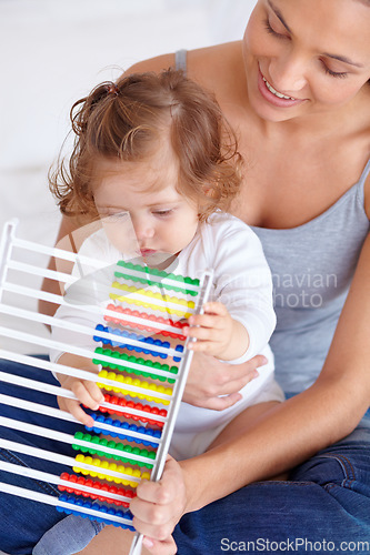 Image of Abacus, education and baby with mother playing, learning and teaching for child development on bed. Bonding, toy and closeup of mom helping kid, infant or toddler with counting in bedroom at home.