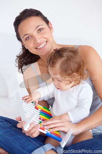 Image of Smile, portrait and baby with mother on abacus playing, learning and teaching for child development on bed. Bonding, toy and mom with kid, infant or toddler with counting in bedroom at home.