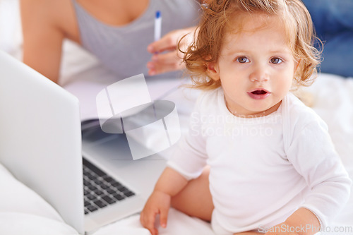 Image of Working, mom and portrait of baby with laptop and multitasking in home. Infant, kid and mother busy with child and computer for freelance remote work, productivity and online project in bedroom