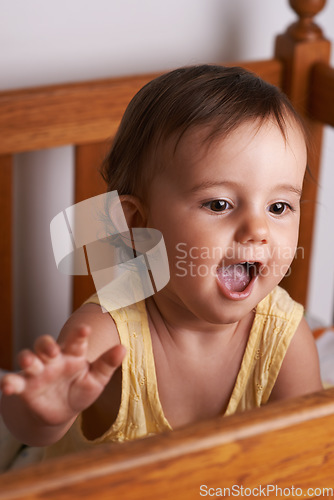 Image of Baby, laughing and crib at home in bedroom with youth, excited and talking with development. Kid, toddler and nursery in a house with smile, happy and curious with morning with sweet and cute girl