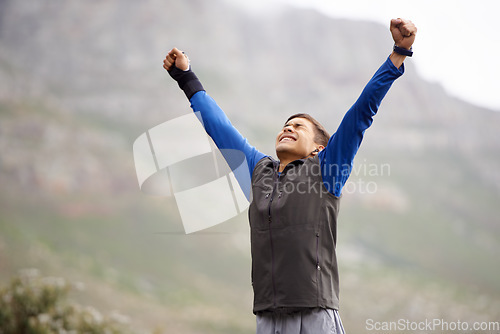 Image of Man, fitness and victory on mountain, happy and winner for achievement, exercise and workout. Success, fitness and climber for training, winner and nature to explore, hobby or health for celebration