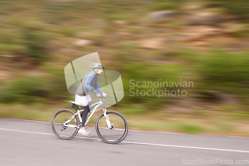 Image of Man, mountain bike and cycling on road in speed for nature adventure or outdoor extreme sports. Male person or cyclist on bicycle for cardio, street or downhill in motion blur, exercise or practice