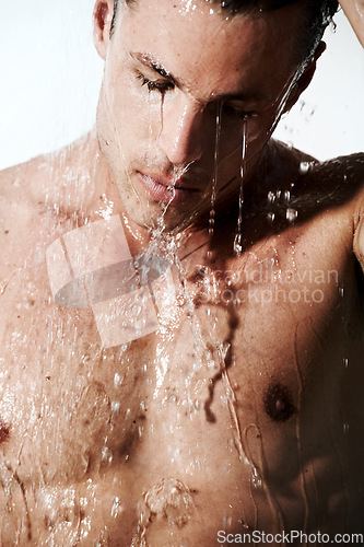 Image of Man in shower cleaning hair, skin and body for morning wellness, hygiene and routine. Grooming, skincare and face of male model with muscle washing with water, healthy self care and calm in bathroom