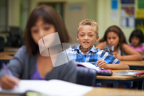 Image of Students, classroom and writing for learning, elementary school and diverse children workbook. Portrait, study and childhood development for education, knowledge and academic information for people