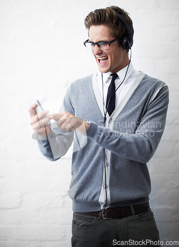 Image of Man, headphones and listening to music and phone for rock song by wall background, singing and sound. Male person, smartphone and streaming radio or podcast, playlist and hearing audio and mobile app