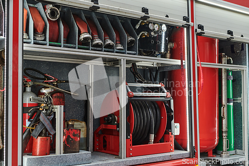 Image of Close-up of essential firefighting equipment on a modern firetruck, showcasing tools and gear ready for emergency response to hazardous fire situations