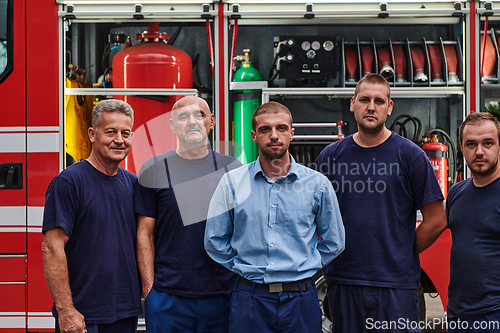 Image of A skilled and dedicated professional firefighting team proudly poses in front of their state of the art firetruck, showcasing their modern equipment and commitment to ensuring public safety.