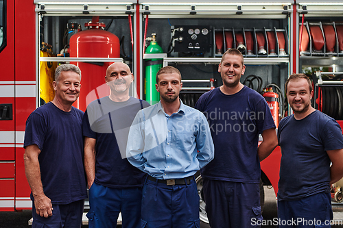 Image of A skilled and dedicated professional firefighting team proudly poses in front of their state of the art firetruck, showcasing their modern equipment and commitment to ensuring public safety.