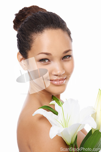 Image of Woman, portrait and flower skincare in studio, smiling and happy with facial treatment by white background. Female person, face and wellness or cosmetics and dermatology, beauty and luxury or organic