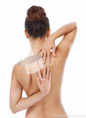 Image of Woman, back and naked in studio for body care, skincare and self love or treatment by white background. Female person, nude and wellness or cosmetics and dermatology, beauty and luxury grooming