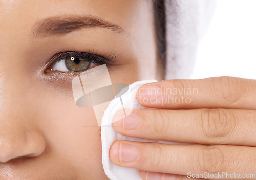 Image of Woman face, cotton pad and closeup for skin care, beauty and cosmetics product with dermatology results in studio. Portrait of person or model eye with hygiene wipe for makeup on a white background