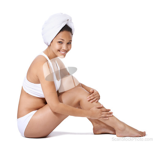 Image of Woman, legs and skin care in studio portrait for hair removal results and beauty on floor on a white background. Young person or happy model in underwear with body cosmetics, skincare and dermatology