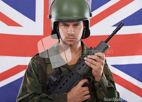 Image of Military, Britain and gun with portrait of man in studio for war, conflict and patriotic. Army, surveillance and security with person and rifle on uk flag for soldier, battlefield or veteran training