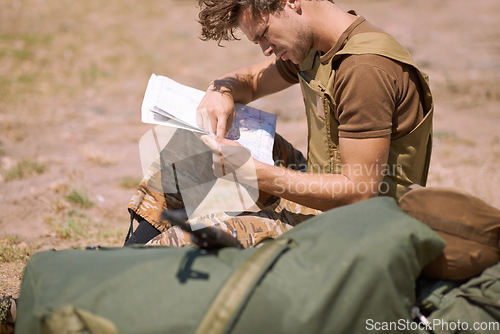 Image of Man with map on battlefield, planning battle location or tactical operation goals for mission in war. Soldier is outdoor at military base camp, check strategy paperwork with army target and attack