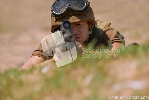 Image of Military, shooting and aim with man and gun in nature for war, conflict and patriotism. Army, surveillance and security with person and sniper rifle training for soldier, battlefield and veteran