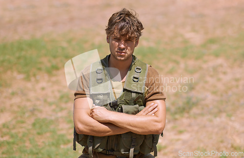 Image of Army, arms crossed and portrait of man in nature for war, conflict and patriotism. Military, surveillance and security with person training on field for soldier, battlefield and veteran protection
