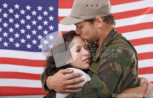 Image of American soldier kiss woman, reunion after war and hug to welcome hero with love and flag. Army man reunite with partner, military veteran in uniform for homecoming with happiness and affection