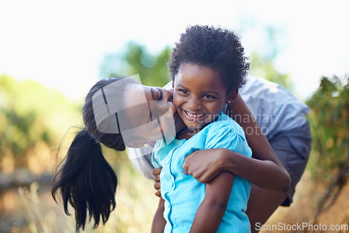 Image of Child, kiss or mother hiking in forest to relax or bond on holiday vacation together in nature. Kid, African mom or happy black family in woods trekking on outdoor adventure with smile, love or hug