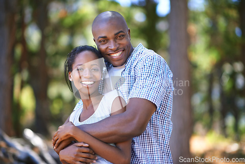 Image of Hug, portrait or black couple hiking in forest to relax or bond on holiday vacation together in nature. Happy, travel or African woman with smile or man in woods trekking on outdoor park adventure