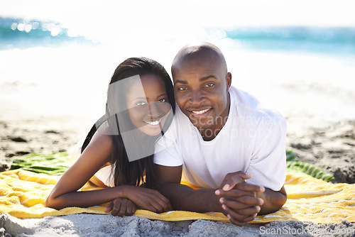 Image of Couple, relaxing on beach towel and portrait with love, sand and romantic for summer vacation. African, resting and happy for holiday, married and seaside in outdoor, beautiful and day off in ocean