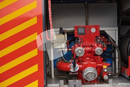 Image of Close-up of essential firefighting equipment on a modern firetruck, showcasing tools and gear ready for emergency response to hazardous fire situations