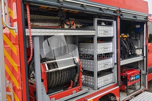 Image of Close-up of essential firefighting equipment on a modern firetruck, showcasing tools and gear ready for emergency response to hazardous fire situations