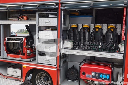 Image of Close-up of essential firefighting equipment on a modern firetruck, showcasing tools and gear ready for emergency response to hazardous fire situations
