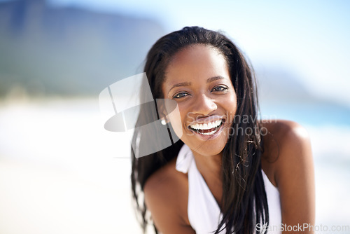 Image of Portrait of black woman on beach, vacation and smile with freedom, sunshine and tropical island travel. Sea, mountain and girl on ocean holiday in summer with adventure, peace and blurred background.