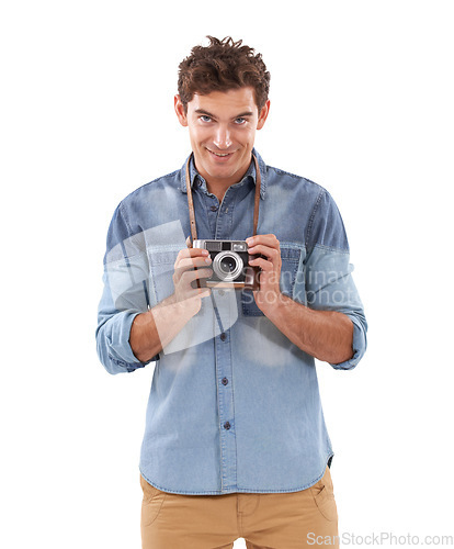 Image of Portrait, smile and camera with a photographer man in studio isolated on a white background for a hobby. Creative, technology and photography with a happy young person holding picture equipment