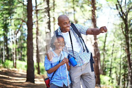 Image of Happy black family, forest and hiking for bonding, fresh air or exploring together in nature. Dad pointing and showing child or kid trees on adventure for holiday, weekend or outdoor trip in woods