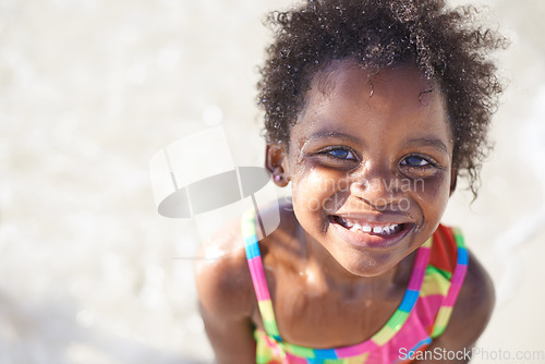 Image of Wet, happy child and portrait on beach sand, swimsuit and summer holiday with sunshine in nature. Black, young girl and smile face for swim on vacation, cape town and ocean for wellness in outdoor