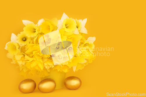 Image of Gold Easter Eggs and Spring Daffodil Flower Arrangement
