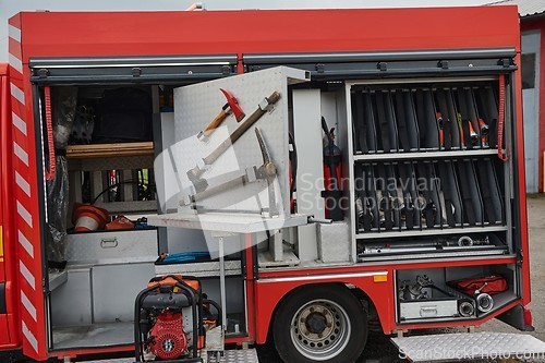 Image of Close-up of essential firefighting equipment on a modern firetruck, showcasing tools and gear ready for emergency response to hazardous fire situations