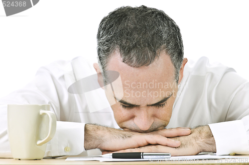 Image of Businessman resting head on hands