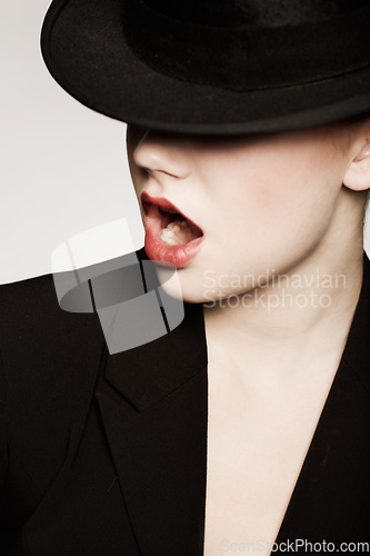 Image of Woman, fashion and gasp for hat, model and makeup with vintage clothes and studio background. Classic, retro and classy with glamour, stylish and jacket for lady, elegance or timeless outfit