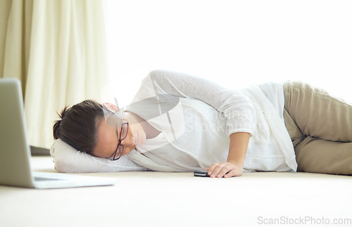 Image of Remote work, burnout and tired woman sleeping on a floor with low energy, exhausted or nap after laptop project. Freelance, fatigue or female person in living room for, dreaming or break in house