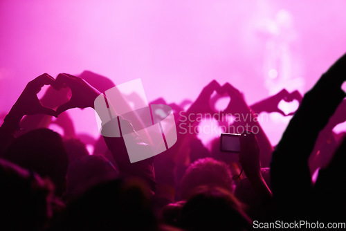 Image of People, heart hands and pink light for music festival for love, support and care for musician. Fans, artist and together with sign, gesture and show for unity, community or solidarity at rock concert