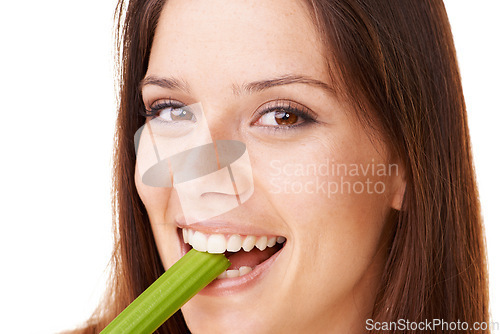 Image of Happy, portrait and woman with celery in a studio for health, wellness and diet snack for lunch. Smile, weight loss and closeup face of young female model eating a vegetable by white background.