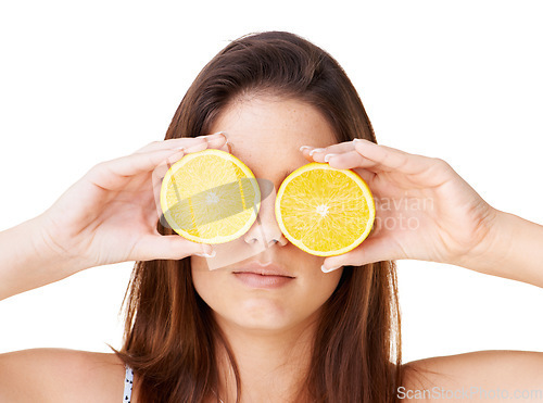 Image of Woman cover face with orange fruits in studio for detox, vegan diet and natural skincare for nutrition on white background. Serious girl, citrus and healthy food for sustainable benefits of vitamin c