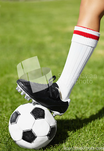 Image of Soccer, shoes and ball on field, sport and outdoor for competition, training and cleats in closeup. Football, person and steps with legs, foot and socks for exercise, grass and pitch for contest