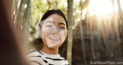 Image of Japanese woman, selfie and bamboo forest for portrait with smile, pride and bush for post on web blog. Girl, person and happy influencer on adventure, trekking and hiking by trees for social network