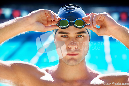 Image of Man, swimming pool and ready in portrait with goggles, cap or sports with exercise for wellness, health or fitness. Swimmer, athlete or person by water for race, contest or workout at games in summer